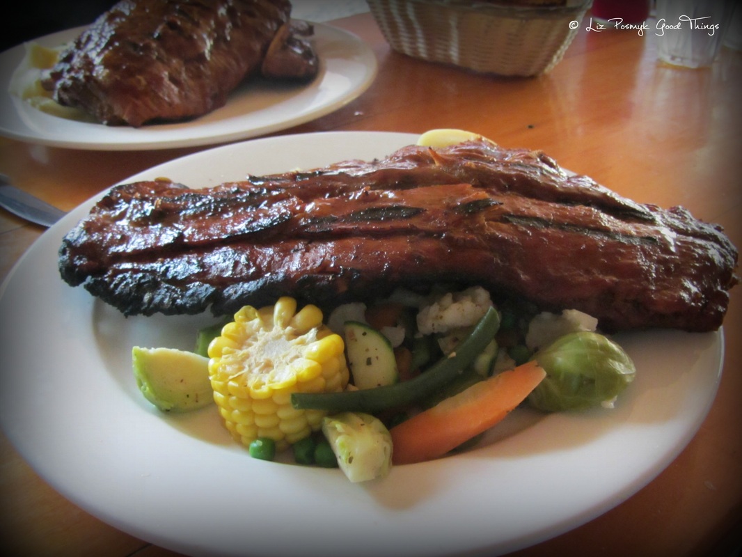 The slab of smoked pork ribs atop vegetables - Crowes Restaurant Gundaroo 