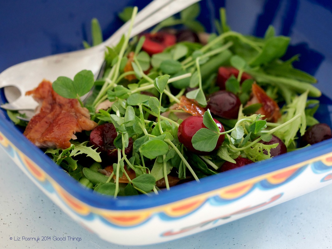 Cherries with salad greens and roasted duck