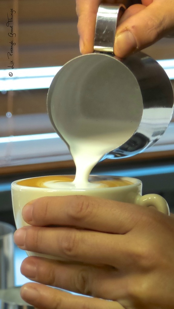 Pouring perfectly stretched milk into a coffee cup