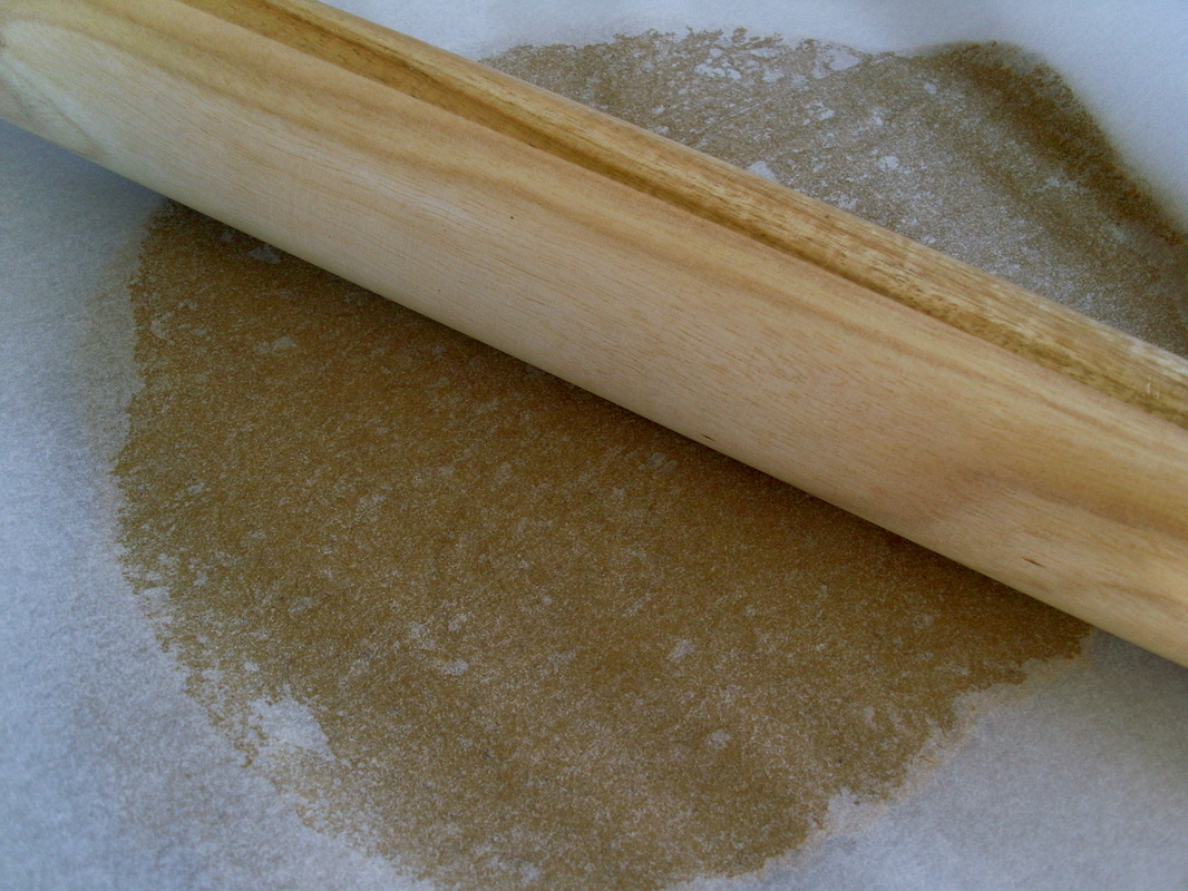 Roll out the gingerbread mixture between sheets of baking parchment