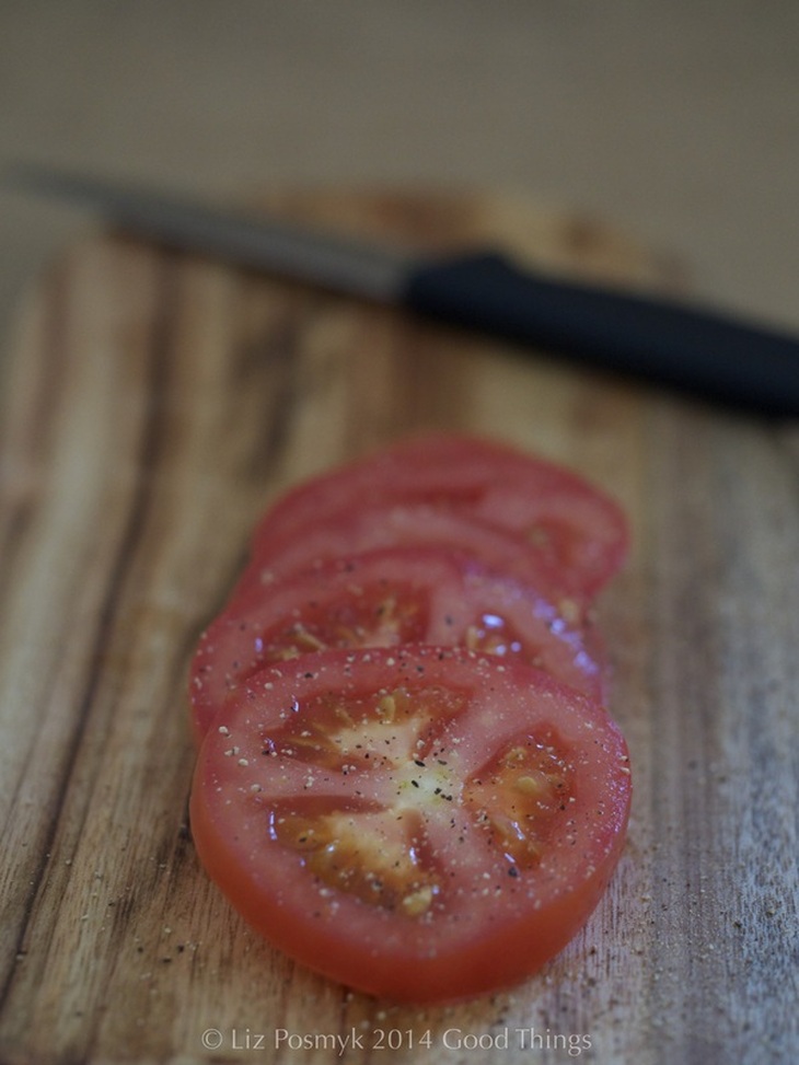 Slice the tomatoes and season to taste with freshly cracked black pepper and smoked salt