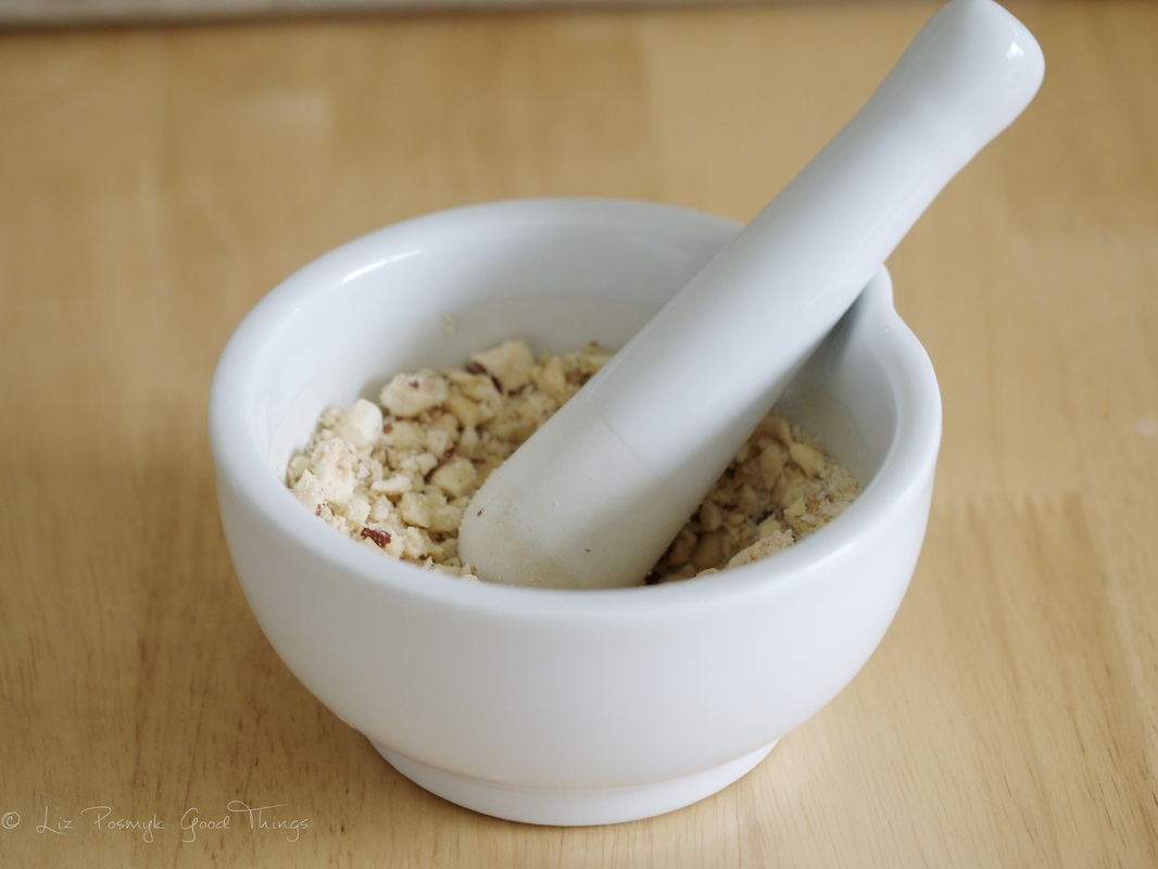 Crush the toasted hazelnuts in a mortar and pestle