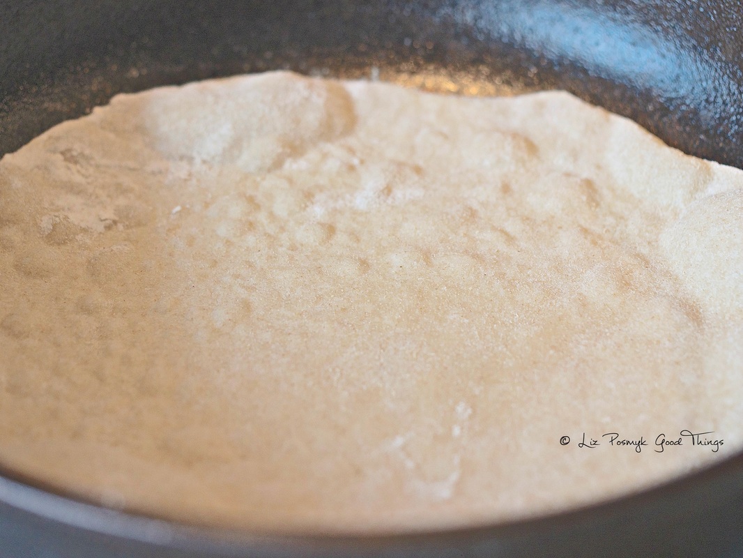 Frying the chapatis in a cast iron skillet