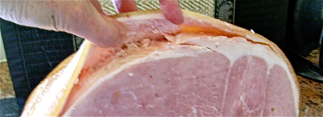 Peel back the skin from the leg of ham