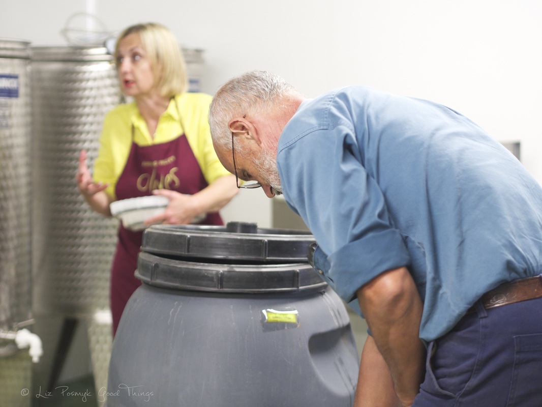 Brenda Sambrook explains the process for olives, while Dean checks the brined olives