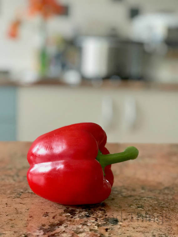 Red bell pepper on a brown granite kitchen bench  - Liz Posmyk Good Things