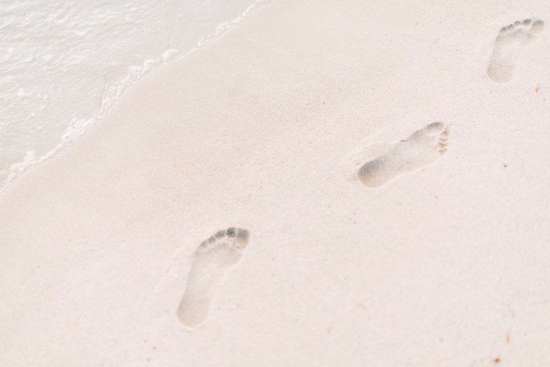 Footprints in the pure white sand